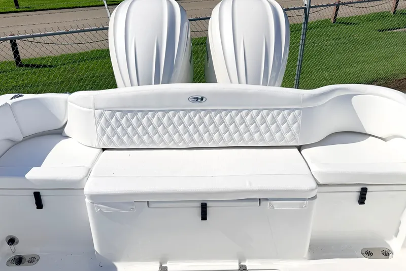 Slide: The Image of 2027 Sea Hunt Ultra 285SL boat with white cushioned seating and diamond pattern upholstery. - 11