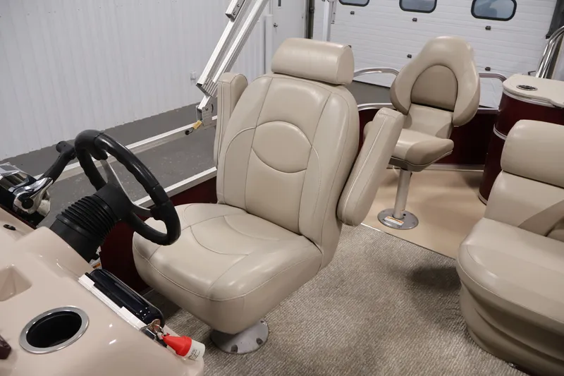 Slide: The Image of 2011 Sylvan Mirage 8520 boat interior with beige leather seating and steering wheel. - 29
