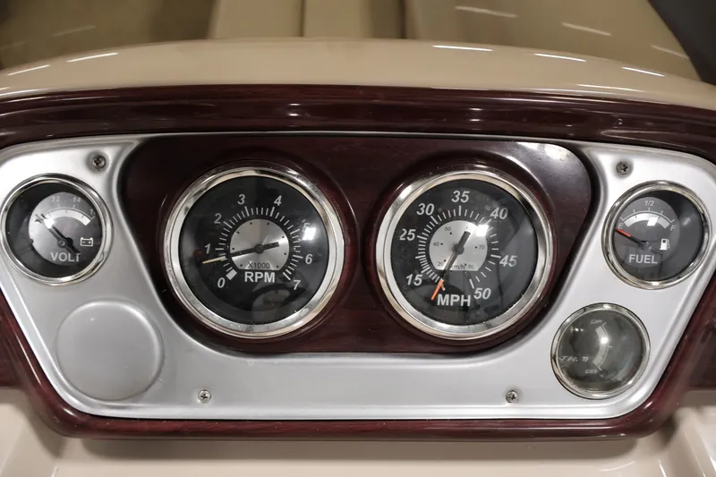 Slide: The Image of Dashboard of 2011 Sylvan Mirage 8520 with volt, RPM, speed, and fuel gauges. - 23