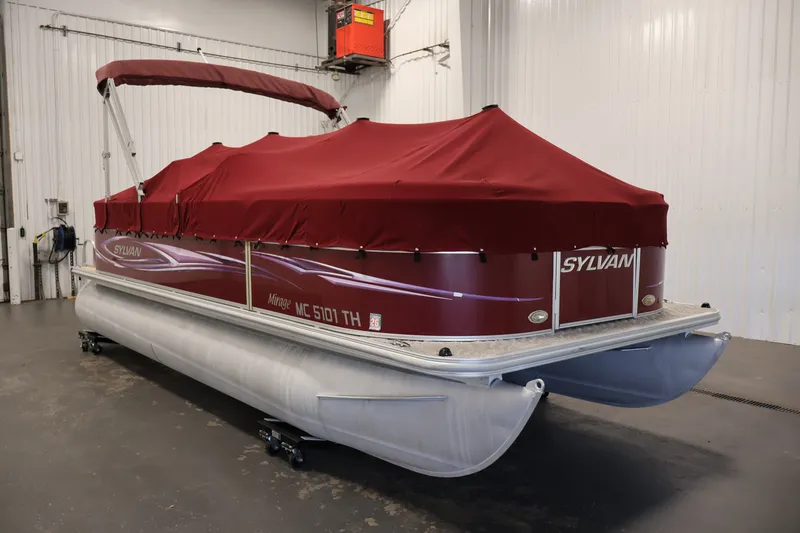 Slide: The Image of 2011 Sylvan Mirage 8520 pontoon boat with red cover in indoor storage. - 41