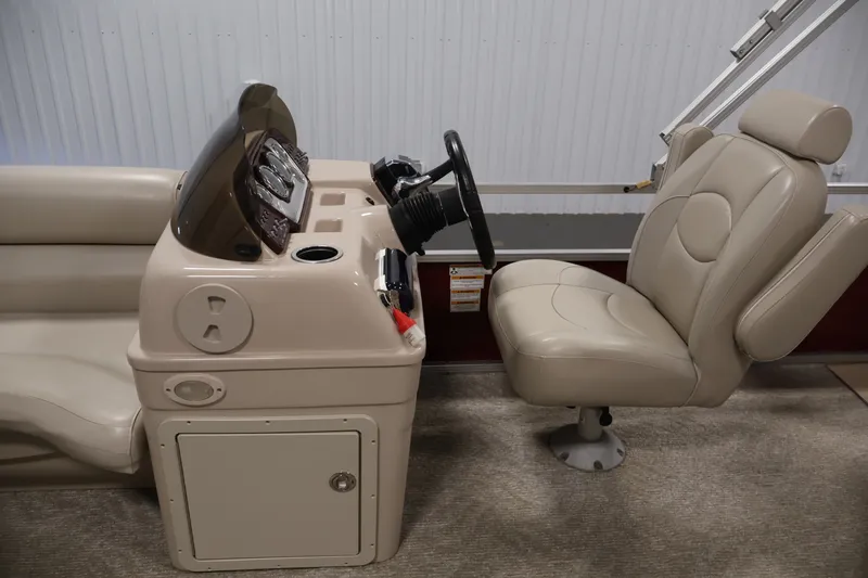 Slide: The Image of 2011 Sylvan Mirage 8520 boat interior with steering console and captain's chair. - 17