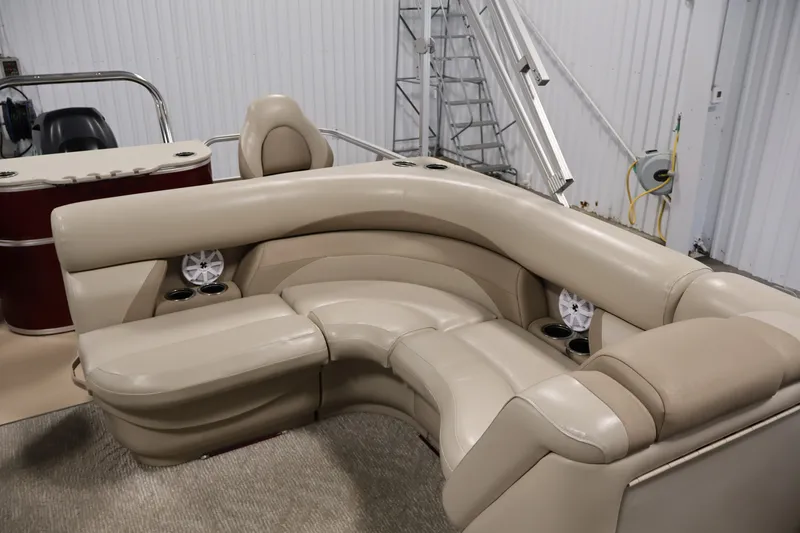 Slide: The Image of Luxurious beige seating on 2011 Sylvan Mirage 8520 pontoon boat, featuring cup holders and speakers. - 30