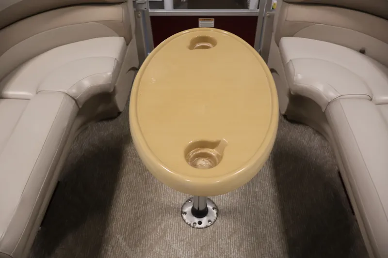 Slide: The Image of 2011 Sylvan Mirage 8520 boat interior with beige seating and oval table. - 16