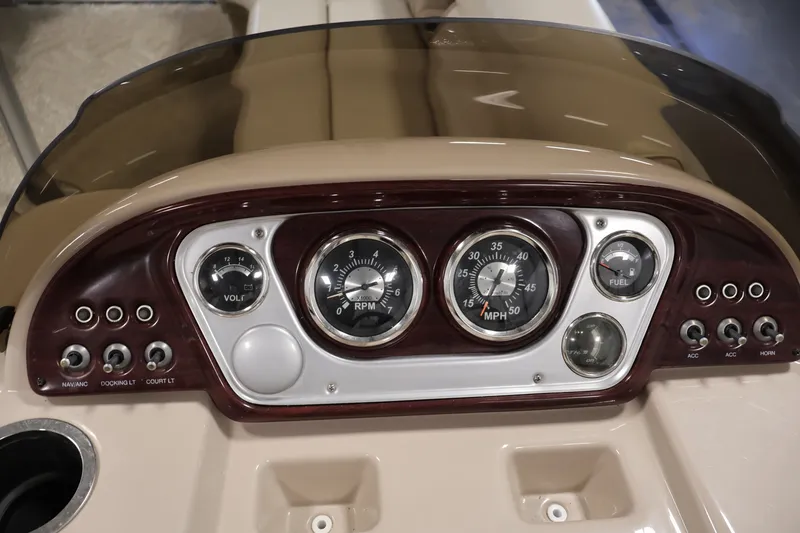 Slide: The Image of Dashboard of a 2011 Sylvan Mirage 8520 boat with gauges and controls. - 21