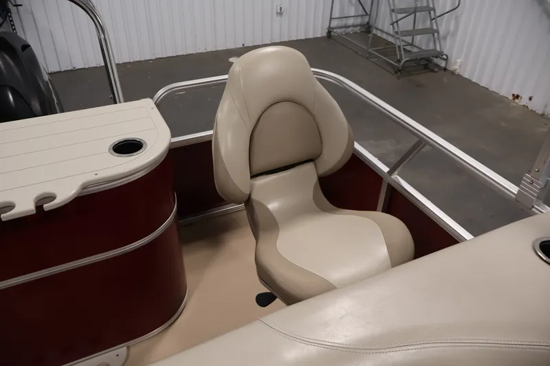Slide: The Image of Beige seating on 2011 Sylvan Mirage 8520 boat, featuring cup holder and railing. - 34