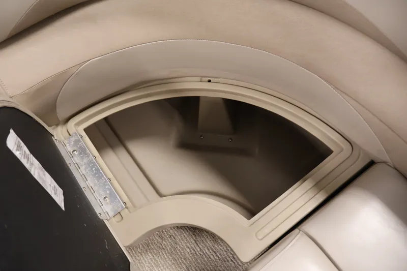 Slide: The Image of Storage compartment in a 2011 Sylvan Mirage 8520 boat, featuring beige upholstery. - 15