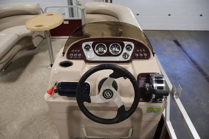 Slide: The Image of 2011 Sylvan Mirage 8520 boat dashboard with steering wheel and controls. - 19