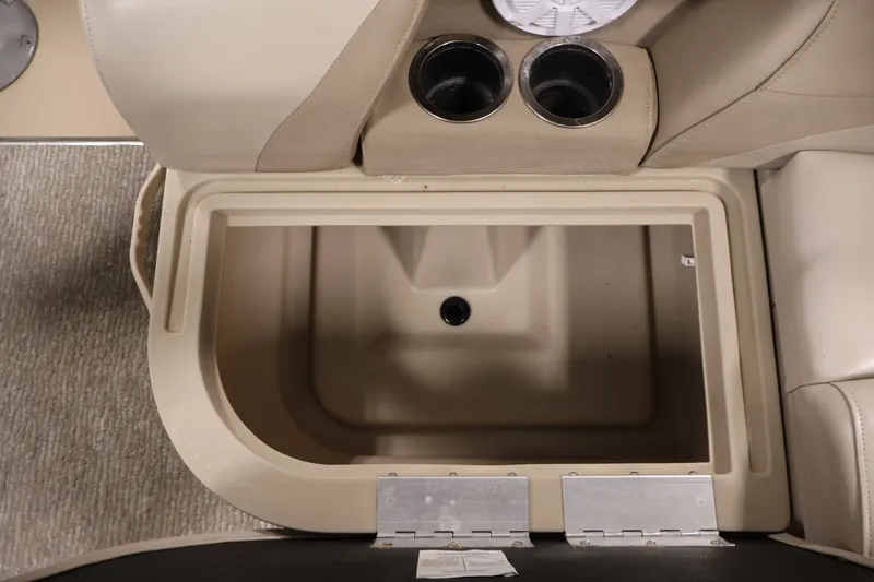 Slide: The Image of Interior storage compartment of 2011 Sylvan Mirage 8520 boat with cup holders. - 32