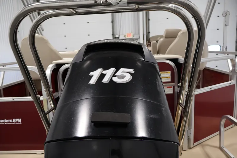 Slide: The Image of 2011 Sylvan Mirage 8520 pontoon boat with 115 HP engine in a garage setting. - 39