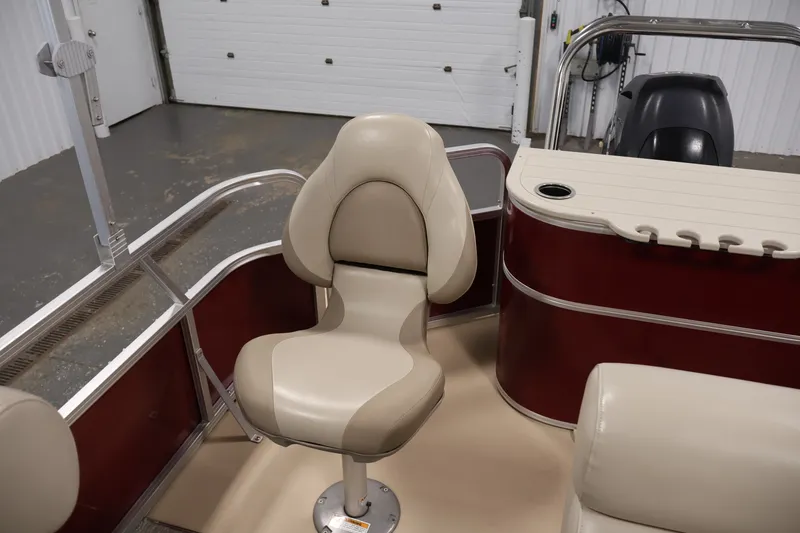 Slide: The Image of 2011 Sylvan Mirage 8520 boat interior with beige seating and red paneling. - 33
