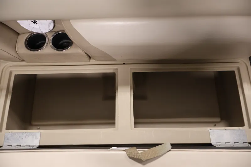 Slide: The Image of Interior storage compartment of a 2011 Sylvan Mirage 8520 boat with cup holders. - 14