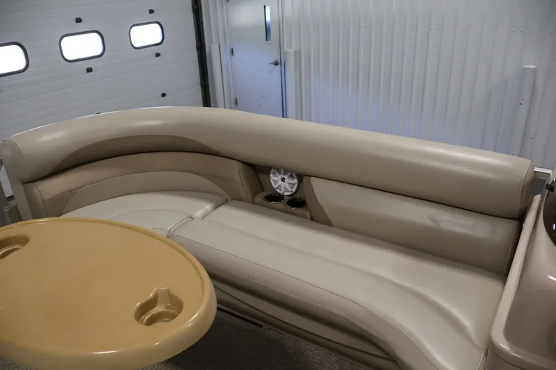 Slide: The Image of Interior of 2011 Sylvan Mirage 8520 pontoon boat with beige seating and table. - 13
