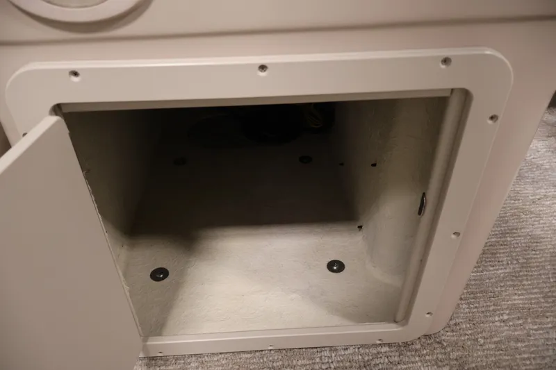 Slide: The Image of Open storage compartment in 2011 Sylvan Mirage 8520 boat interior. - 18