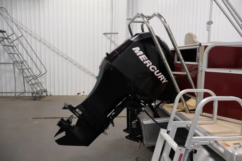 Slide: The Image of 2011 Sylvan Mirage 8520 pontoon boat with Mercury outboard motor in a storage facility. - 38