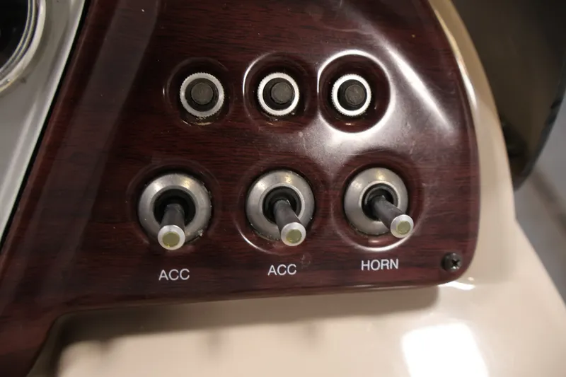Slide: The Image of Control panel of a 2011 Sylvan Mirage 8520 with switches for accessories and horn. - 24