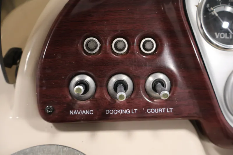 Slide: The Image of Control panel of a 2011 Sylvan Mirage 8520 boat with labeled switches. - 22