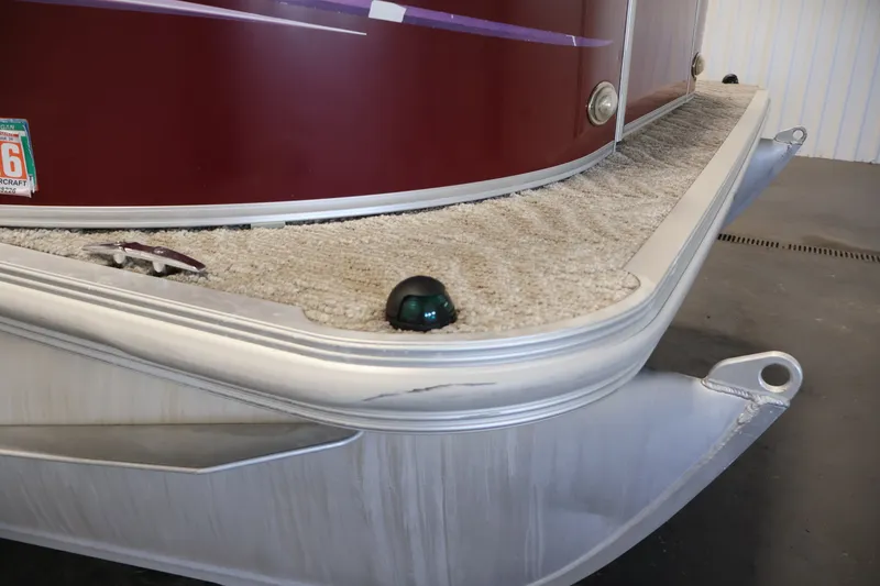 Slide: The Image of 2011 Sylvan Mirage 8520 pontoon boat with red exterior and carpeted deck. - 45