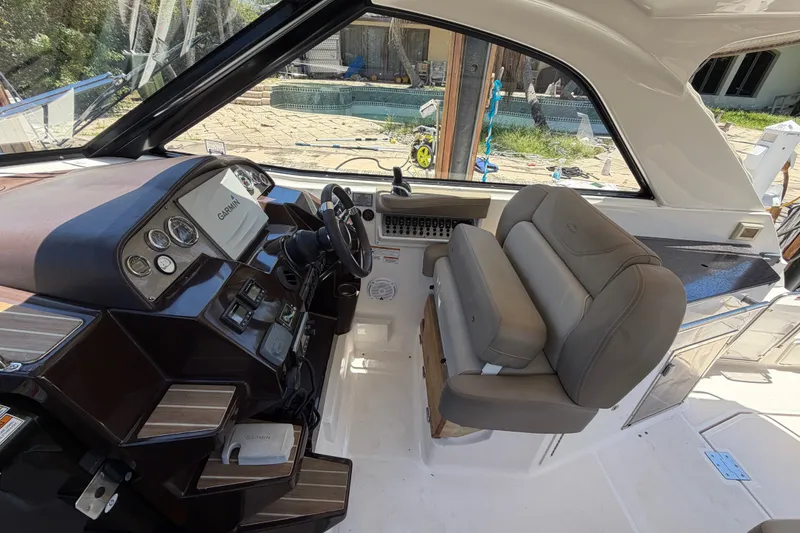 Slide: The Image of Interior of a 2015 Regal 35 Sport Coupe boat with modern dashboard and seating. - 15