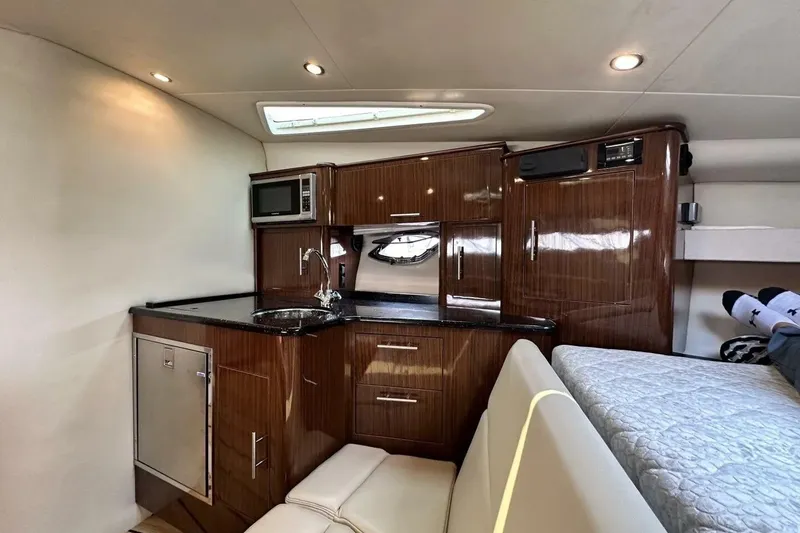 Slide: The Image of Luxurious interior of 2015 Regal 35 Sport Coupe yacht with kitchenette and cozy seating. - 19