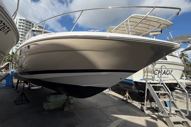 Slide: The Image of 2015 Regal 35 Sport Coupe boat on dry dock under a clear sky. - 8