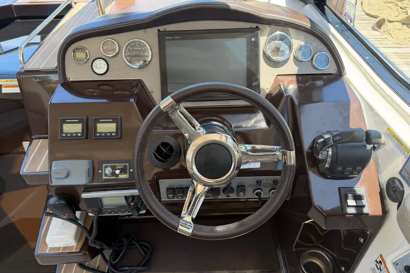 Slide: The Image of Control panel of a 2015 Regal 35 Sport Coupe boat with steering wheel and gauges. - 11