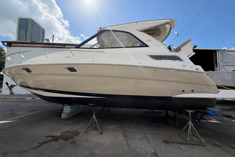 Slide: The Image of 2015 Regal 35 Sport Coupe yacht on stands, with urban skyline background. - 10