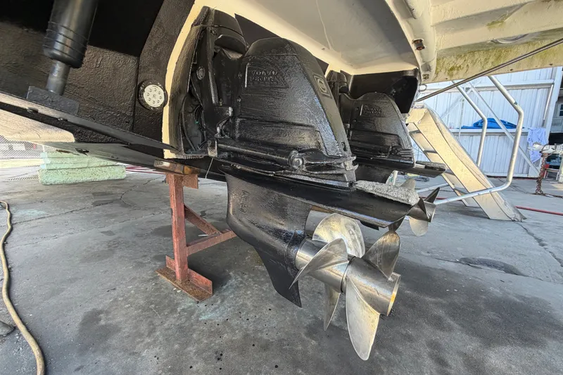 Slide: The Image of 2015 Regal 35 Sport Coupe boat propellers and stern drive in maintenance area. - 5