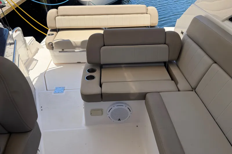 Slide: The Image of 2015 Regal 35 Sport Coupe interior with beige seating and cup holders. - 14