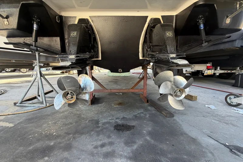 Slide: The Image of 2015 Regal 35 Sport Coupe boat propellers and stern drive in maintenance area. - 6
