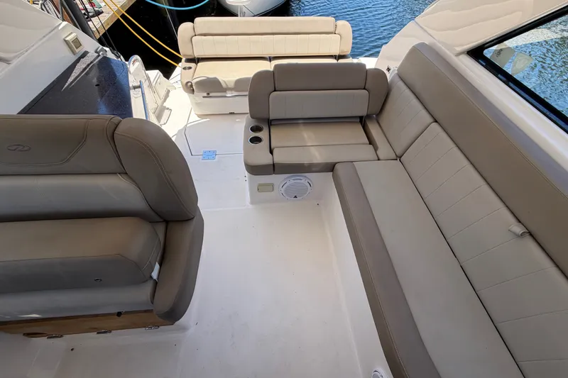 Slide: The Image of 2015 Regal 35 Sport Coupe interior with beige seating and cup holders. - 17