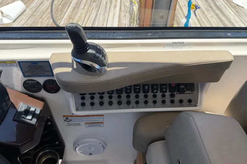 Slide: The Image of Control panel of a 2015 Regal 35 Sport Coupe boat with joystick and switches. - 12