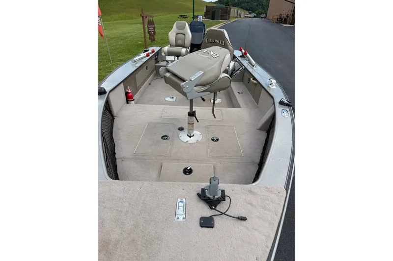 Slide: The Image of 2001 Lund 1775 Pro-V boat interior with seating and fishing equipment. - 1