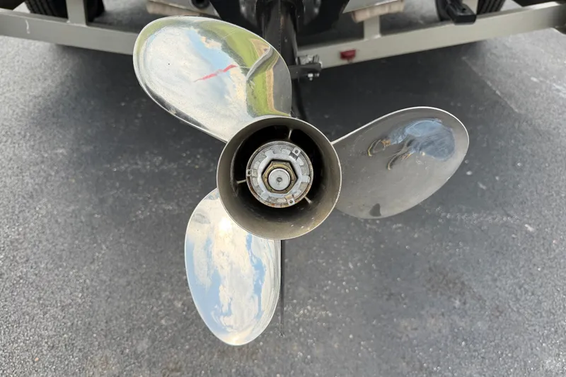Slide: The Image of Close-up of a 2001 Lund 1775 Pro-V boat propeller on asphalt. - 7