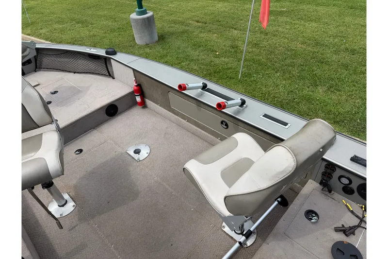 Slide: The Image of 2001 Lund 1775 Pro-V boat interior with seating and fishing rod holders. - 10