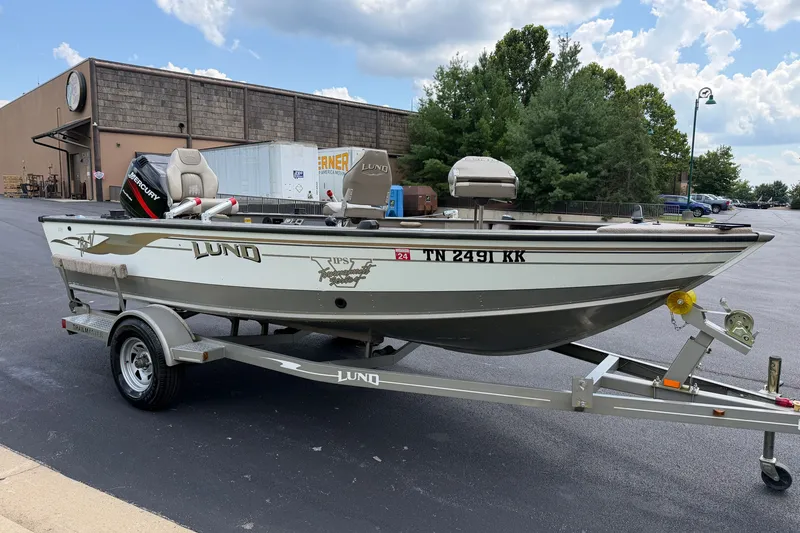 Slide: The Image of 2001 Lund 1775 Pro-V fishing boat on trailer in parking lot. - 6