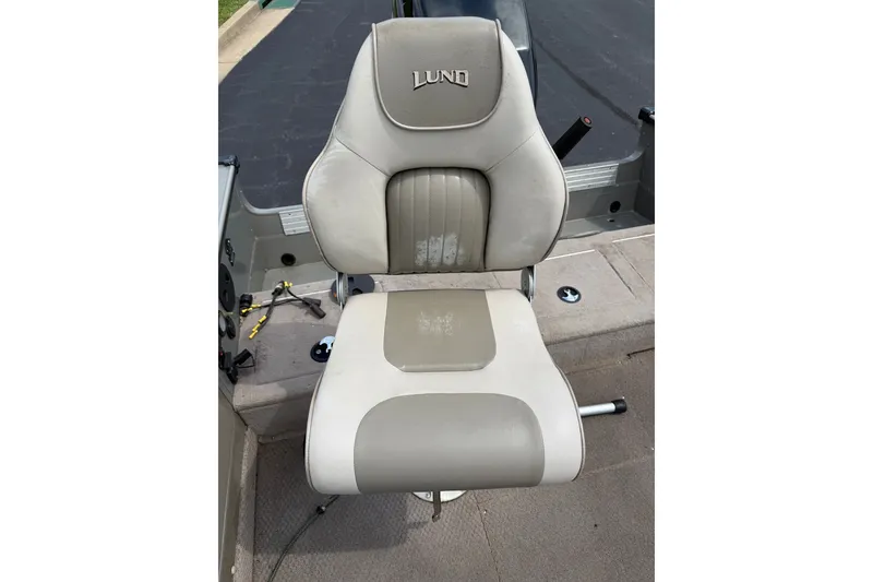 Slide: The Image of Boat seat on a 2001 Lund 1775 Pro-V, featuring beige and gray upholstery. - 8