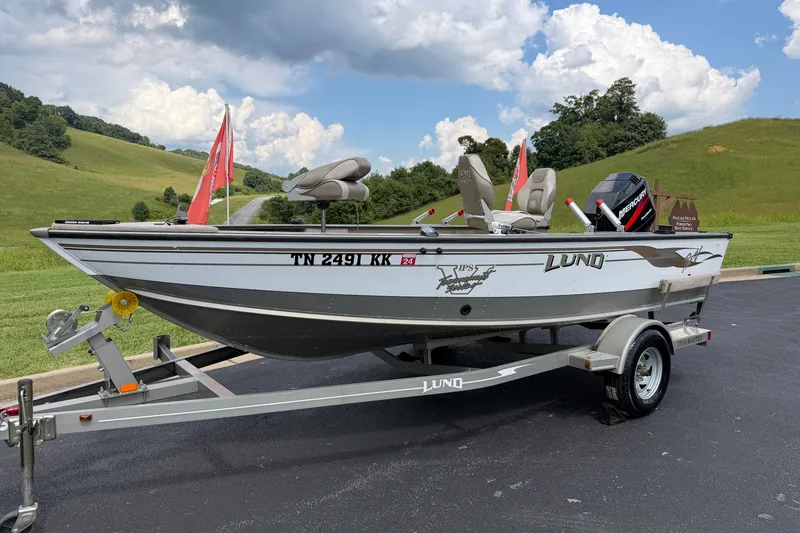 Slide: The Image of 2001 Lund 1775 Pro-V fishing boat on trailer, scenic countryside background. - 3