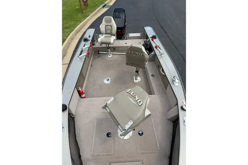 Slide: The Image of 2001 Lund 1775 Pro-V boat interior with seating and fishing equipment. - 11