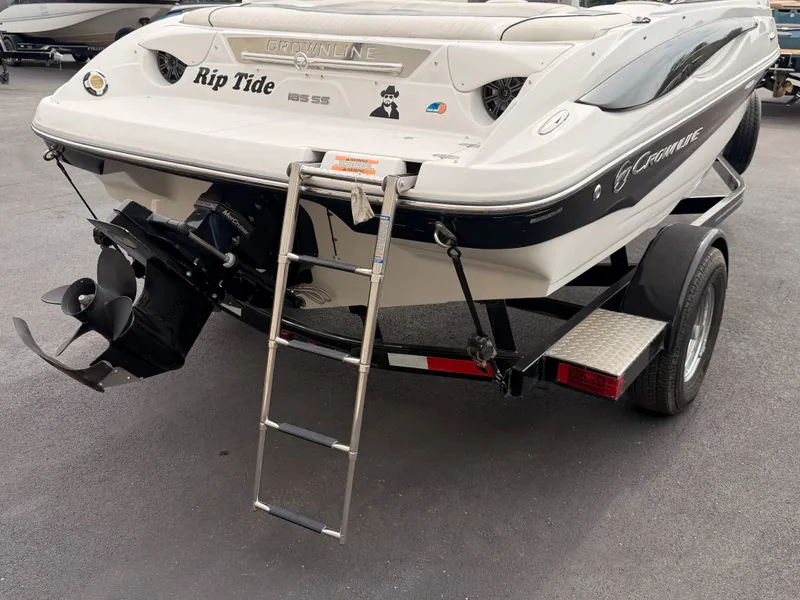 Slide: The Image of The image shows a 2009 Crownline 185 SS boat with a swim ladder at the stern. - 13