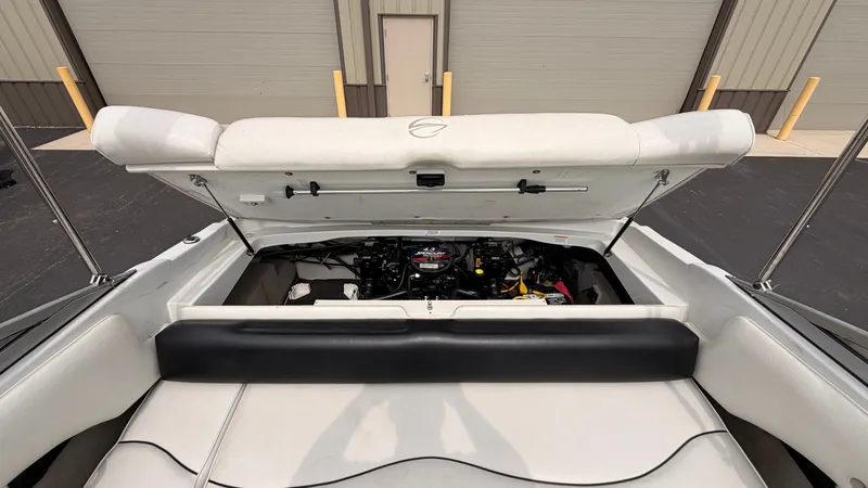 Slide: The Image of The image shows the engine compartment of a 2009 Crownline 185 SS boat with the cover open. - 21