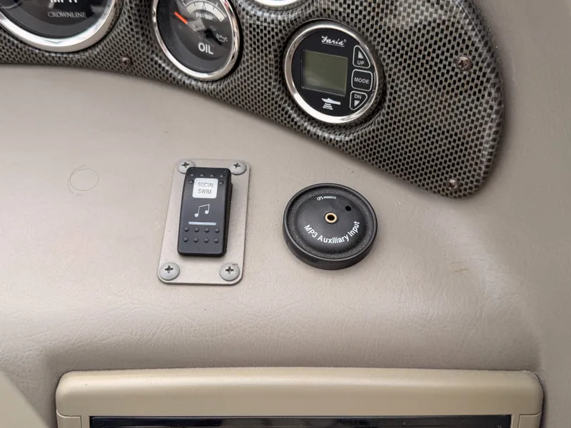 Slide: The Image of Close-up of a 2009 Crownline 185 SS boat dashboard with various gauges. - 38