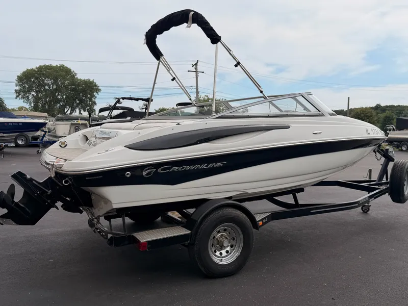 Slide: The Image of A white and black 2009 Crownline 185 SS boat on a trailer, ready for transport. - 7