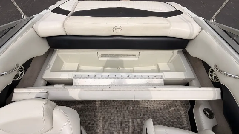 Slide: The Image of The image shows the interior of a 2009 Crownline 185 SS boat with white upholstery. - 20
