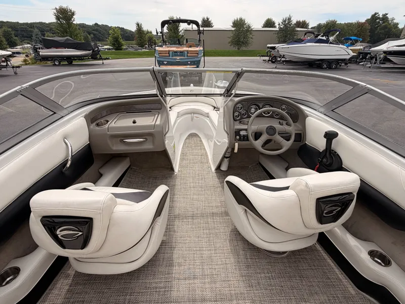Slide: The Image of Interior view of a 2009 Crownline 185 SS boat with two white seats and a helm station. - 26