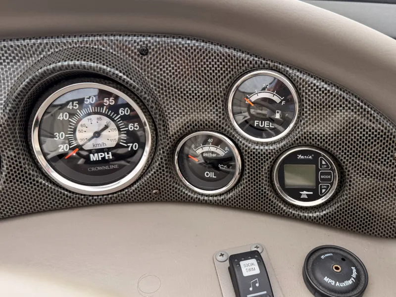 Slide: The Image of Dashboard of a 2009 Crownline 185 SS boat with speed, fuel, and oil gauges. - 37