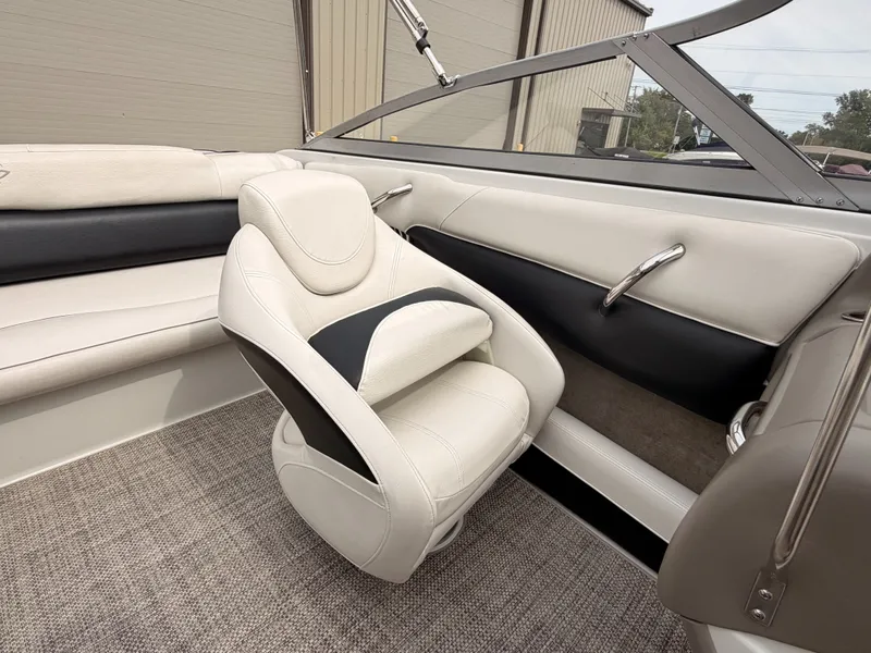 Slide: The Image of Interior of a 2009 Crownline 185 SS with beige and black upholstered seating. - 30