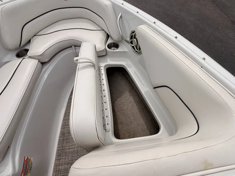 Slide: The Image of The image shows the interior of a 2009 Crownline 185 SS boat with white upholstery. - 48