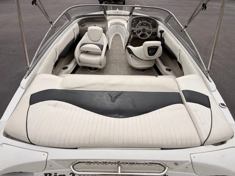 Slide: The Image of The image shows the cockpit of a 2009 Crownline 185 SS boat with white upholstery. - 16