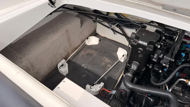 Slide: The Image of Engine compartment of a 2009 Crownline 185 SS boat with visible wiring and components. - 23