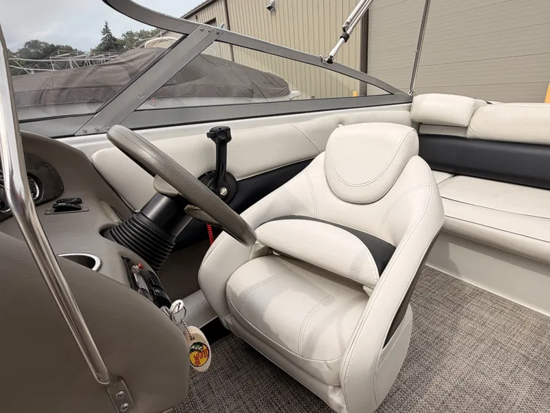 Slide: The Image of The image shows the cockpit of a 2009 Crownline 185 SS with a white leather seat. - 31